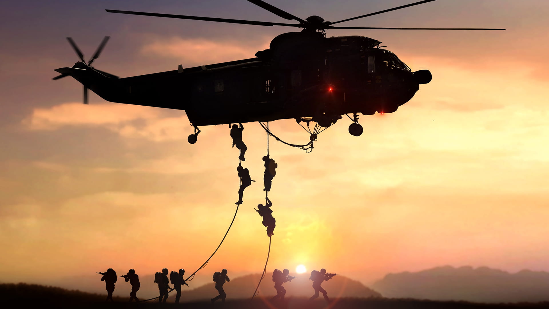 Soldiers descend from a helicopter
